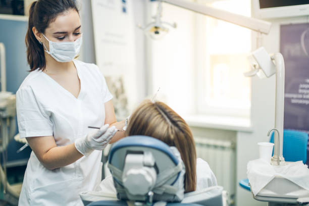 Professional dentist treating patient's teeth with care.